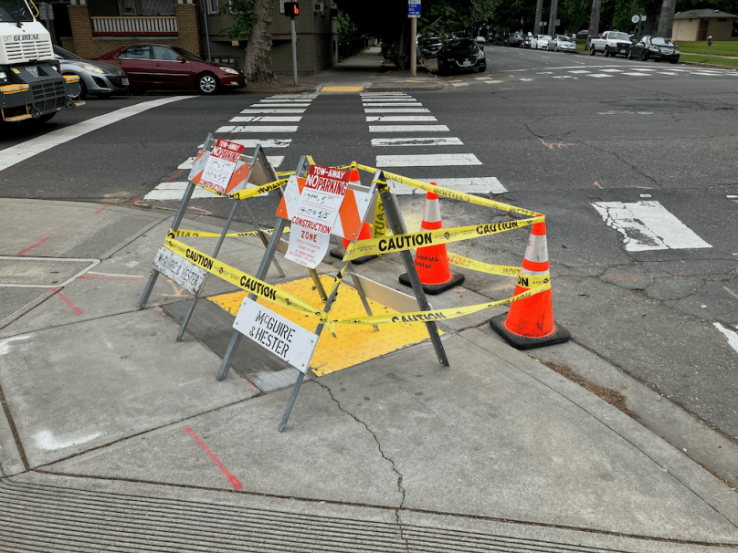 photo of diagonal curb ramp, now illegal under PROWAG, installed May 2023