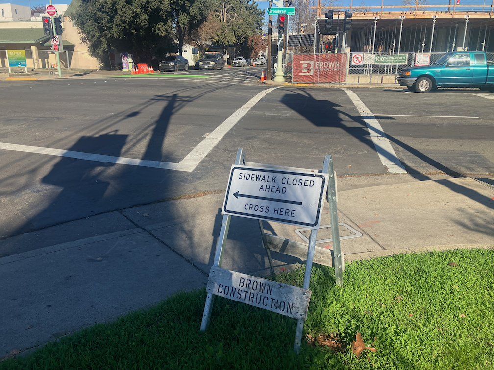 photo of Broadway at 19th St, no barricade for closed crosswalk, ped signal not covered