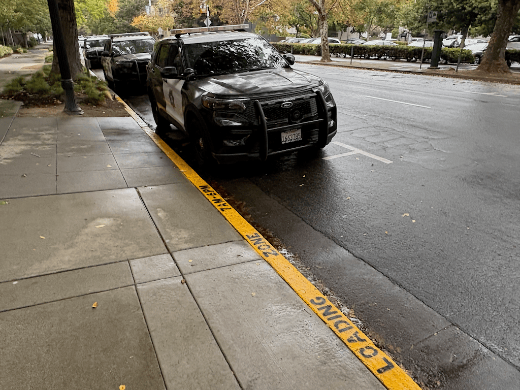 photo of SacRT police parked illegally in commercial loading zone, 1102 Q St
