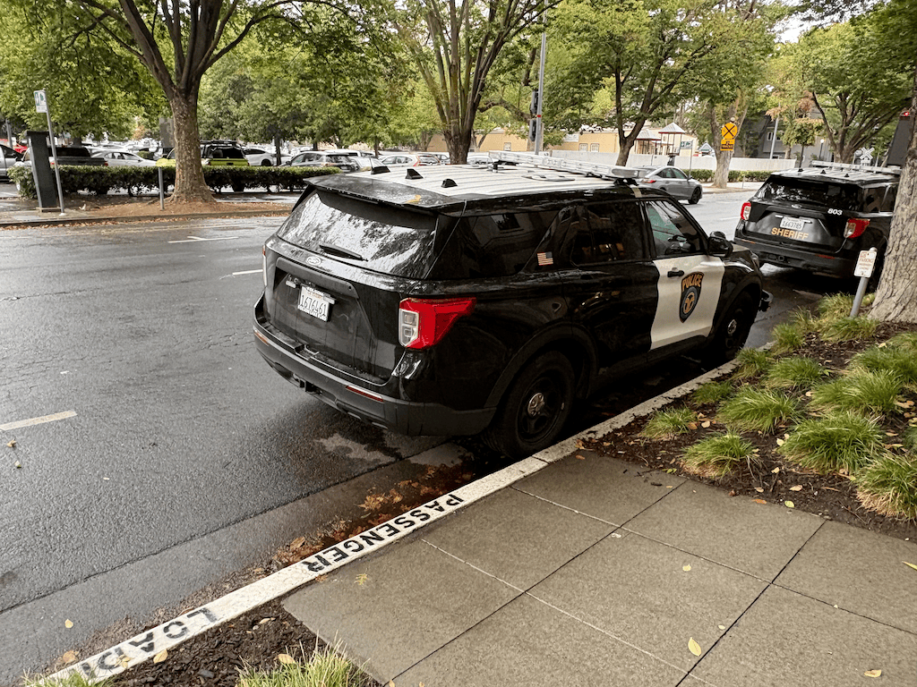 photo of SacRT police parked illegally in passenger loading zone, 1102 Q St